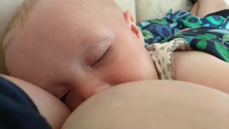 Sovende baby ved brystet